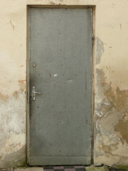 Simple metal door with scratches and small holes.